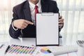 Business man Showing a blank paper at office with desktop computer and documents on his desk Royalty Free Stock Photo