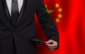 Business man showing his empty pockets on Chinese flag background Royalty Free Stock Photo