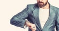 Business man showing time on his wrist watch. Hand in with wrist watch in a business suit. Elegant handsome man in suit Royalty Free Stock Photo