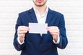 Business man showing white paper. Man  wearing blue suit and holding white blank card. Lifestyle and working concept. Business and Royalty Free Stock Photo