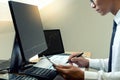 Business man sit at ther table looking at computer laptop