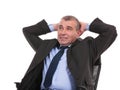 Business man sits on chair with hands behind head Royalty Free Stock Photo