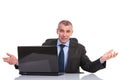 Business man sits at laptop and welcomes you Royalty Free Stock Photo