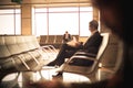 Business man sitting at airport, waiting his flight . Royalty Free Stock Photo