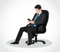 Business man sitting in armchair and looking at tablet