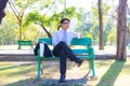 Business man,He is sitting on bench in park.He is thinking about business. Royalty Free Stock Photo