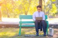 Business man,He is sitting on bench in park.He is thinking about business. Royalty Free Stock Photo