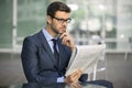Business man sitting at coffee shop with a newspaper Royalty Free Stock Photo