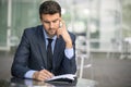 Business man sitting at coffee shop with paperwork Royalty Free Stock Photo