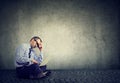 Business man sitting on a floor and using a laptop computer Royalty Free Stock Photo