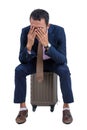 A business man sitting on his luggage is feeling sad and hands o Royalty Free Stock Photo