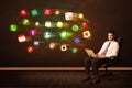 Business man sitting in office chair with laptop and colorful app icons Royalty Free Stock Photo