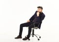 Business man sitting on office chair with serious face Royalty Free Stock Photo