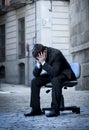 Business Man sitting on Office Chair on Street in stress Royalty Free Stock Photo