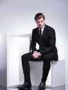 Business man sitting on a white modern chair Royalty Free Stock Photo