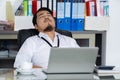 Business man sleeping on working desk between using laptop computer Royalty Free Stock Photo