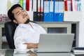 Business man sleeping on working desk between using laptop computer Royalty Free Stock Photo