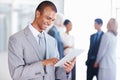 Business man smiling while using digital tablet. Portrait of African American business man using digital tablet with Royalty Free Stock Photo