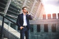 Business man stand at street holding a smartphone in office park Royalty Free Stock Photo