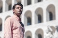 Business man standing in front of a building. Wearing a shirt. Look into the distance Royalty Free Stock Photo