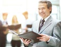 Business man standing with his staff in background at office Royalty Free Stock Photo