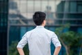 Business man standing looking new modern building, view from the Royalty Free Stock Photo