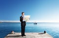 Business man standing on pier with map Royalty Free Stock Photo