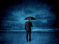 Business man standing in rain with an umbrella Royalty Free Stock Photo