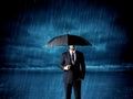 Business man standing in rain with an umbrella Royalty Free Stock Photo