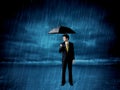 Business man standing in rain with an umbrella Royalty Free Stock Photo