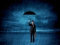 Business man standing in rain with an umbrella Royalty Free Stock Photo