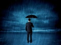 Business man standing in rain with an umbrella Royalty Free Stock Photo