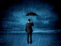 Business man standing in rain with an umbrella Royalty Free Stock Photo