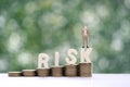 Business man standing on risk word on natural green background, Business investment and Risk management concept.Financial risk Royalty Free Stock Photo