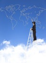 Business man standing a stepladder and drawing global map Royalty Free Stock Photo