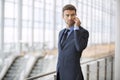 Business man standing talking on his cell phone serious Royalty Free Stock Photo