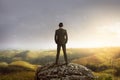 Business man standing on the top of the mountain looking at the Royalty Free Stock Photo