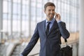 Business man standing walking talking on his cell phone Royalty Free Stock Photo