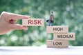 Business man standing on wooden block on natural green background, Business investment and Risk management concept.Financial risk Royalty Free Stock Photo