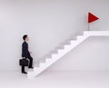 Business man stepping up on stairs to red flag (business success Royalty Free Stock Photo