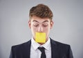 Business man, sticky note and mouth in studio for silence, reminder and thinking by white background. Person, employee Royalty Free Stock Photo