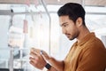 Business man, sticky note and planning on glass board, writing and focus in startup workplace. Young businessman Royalty Free Stock Photo