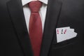 Business man in suit with aces in the pocket of his jacket. Metaphor to confidence in winning. Businessman ready for risk and dev Royalty Free Stock Photo