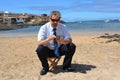 Business man in suit on the beach calling by mobil