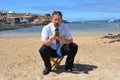 Business man in suit on the beach calling by mobil