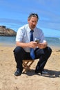 Business man in suit on the beach calling by mobil