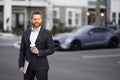 Business man in suit. Businessman walking in city. Hispanic man walk on street. Business man with laptop and coffee Royalty Free Stock Photo