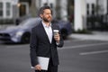 Business man in suit. Businessman walking in city. Hispanic man walk on street. Business man with laptop and coffee Royalty Free Stock Photo