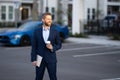 Business man in suit. Businessman walking in city. Hispanic man walk on street. Business man with laptop and coffee Royalty Free Stock Photo