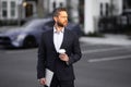 Business man in suit. Businessman walking in city. Hispanic man walk on street. Business man with laptop and coffee Royalty Free Stock Photo